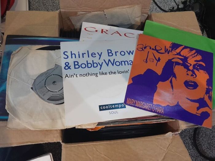 a box of 7" singles. 45 rpm vinyl records.