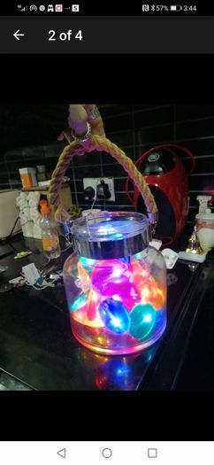 large glass candle lantern with coloured lights