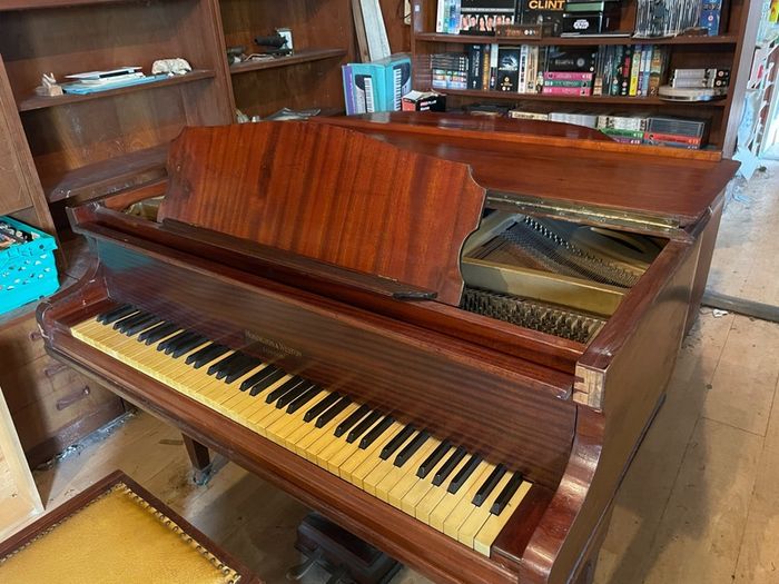 a circa-1931 Monington & Weston baby grand with matching stool.