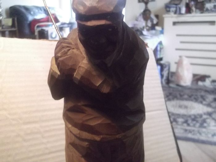 a antique carved wood golfer