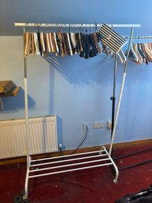 white clothes Rack  features an adjustable height and a built-in shoe rack
