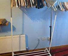 white clothes Rack  features an adjustable height and a built-in shoe rack