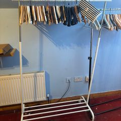 white clothes Rack  features an adjustable height and a built-in shoe rack