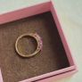 Beautiful yellow gold ring featuring three stunning rubies surrounded by sparkling cubic zirconia stones. Size M, in beautiful condition. Image 7
