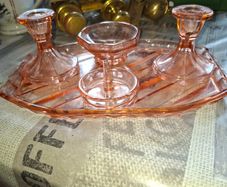 Pink Glass Art Deco Vanity Set, likely dating from the 1920s or 1930s. The set includes a Container, a Ring Holder, Two Candlesticks, and a Vanity Tray, Postage or Collection