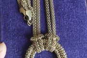 Vintage necklace with a pendant in the form of a ring and links in the form of a snake in gold tone.