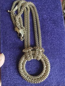 Vintage necklace with a pendant in the form of a ring and links in the form of a snake in gold tone.