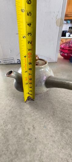Japanese Side-Handle Teapot Kyusu 300cc  speckled ceramic side-handle teapot (kyusu) features a hand-painted pink cherry blossom (sakura) or plum floral branch motif against a light gray or cream stoneware body