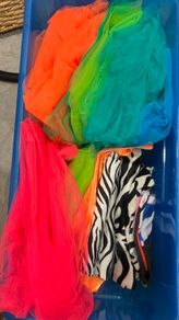 Box of assorted colourful tulle and fabric materials