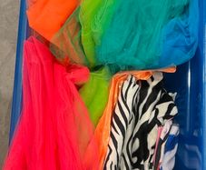Box of assorted colourful tulle and fabric materials