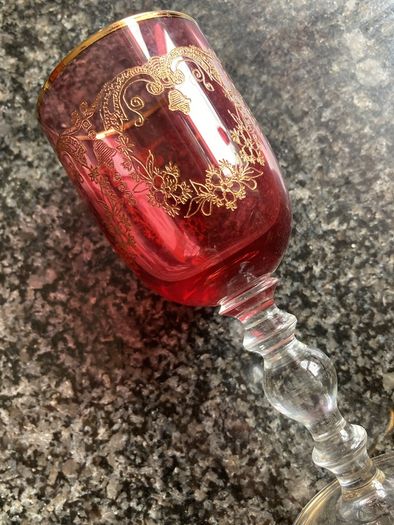 Pair of cranberry glass gold etched antique wine glasses