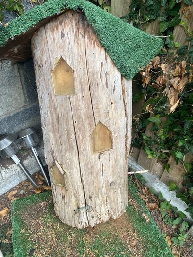 Fairy house perfect for little girl, made from tree trunk & carved out windows & swing, just needs some maintenance