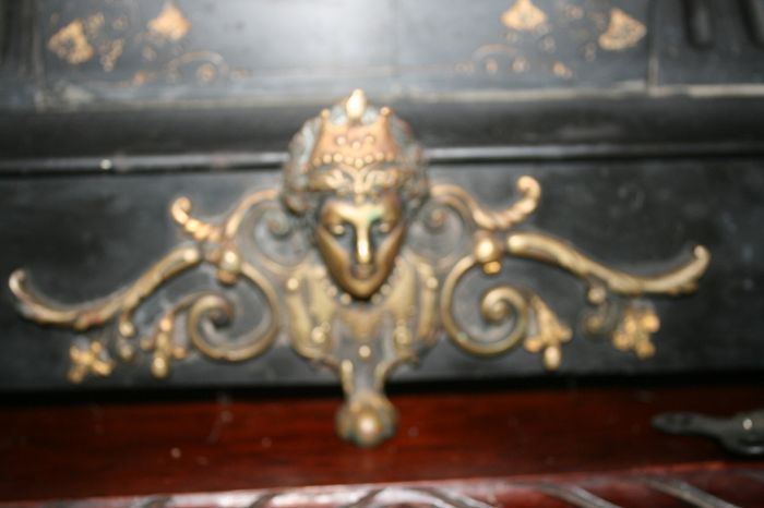 Victorian French Black Slate Mantle Clock (Very large and heavy) with bronze ornamentation Oversized. Open escarpment slate plate Roman numerals. Circa 1890s. Accented with Trojan head. Flanked by two Hellenistic ladies heads on sides. Rose cartouche mask