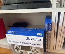 PS4 console with dual shock 4 controller and two COD games