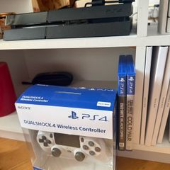 PS4 console with dual shock 4 controller and two COD games
