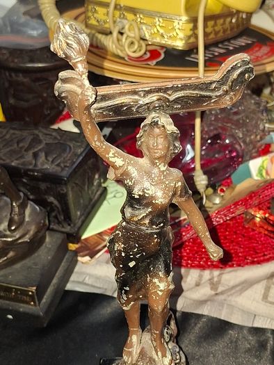 A Pair of Antique French Spelter Statues titled La Force (The Strength) and Le Pouvoir (The Power). The feature a male and female figure standing a top lions, raising up flaming torches