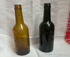 Antique Cork Advertising Bottles x2