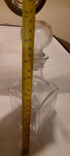 Art deco glass whiskey decanter with lid,,buyer collects or pays postage thank you, good patina condition,,sold as is, see pictures for condition,,