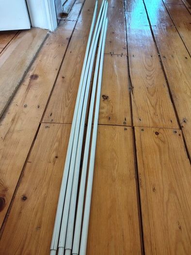 Five white extendable net curtain rods