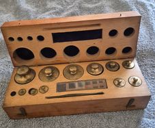 Cased set of brass vintage chemist / apothecary weights.