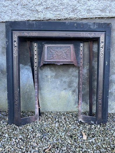 Wooden fireplace surround with carved details
