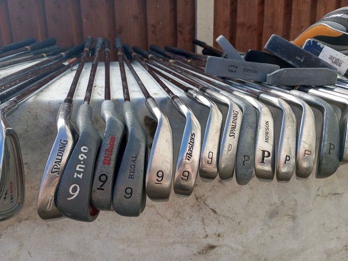 A selection of golf clubs and bags. All right handed clubs.