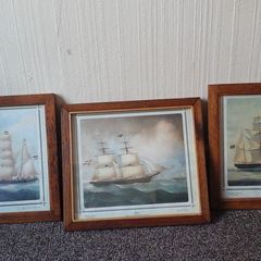 Framed pictures of old ships.