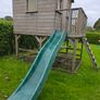 Wooden playhouse with slide and swings Image 2