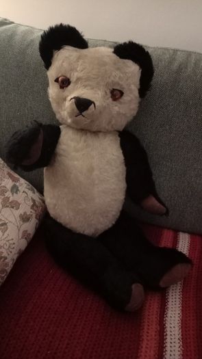 Antique straw-filled panda teddy bear