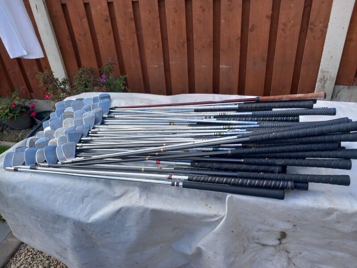 A selection of Golf clubs. Bags and golf balls.
