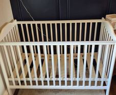 Nested wooden cot with mattress