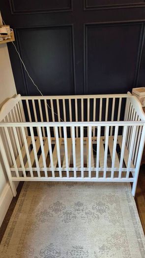 Nested wooden cot with mattress