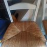 counter top high chairs, white with wicker seats. Slight wear as shown on 1 but 2 in very good condition. Slight distressed  style. Image 3