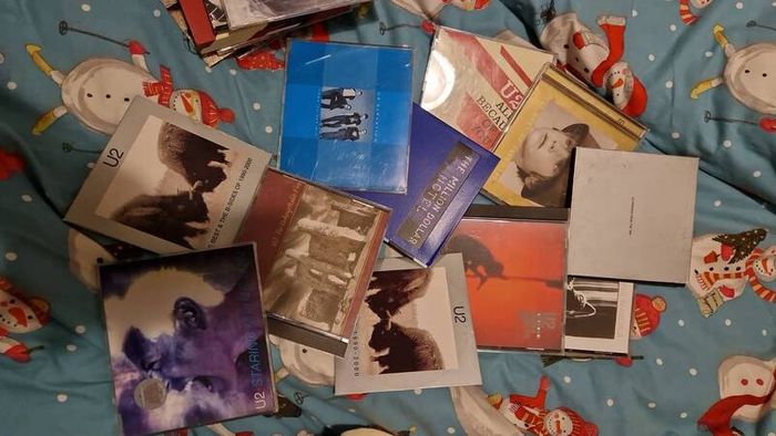 bag of U2 promo CD singles, CD albums and DVD sets