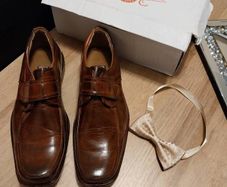 As new in box size 4 brown leather with bow tie also