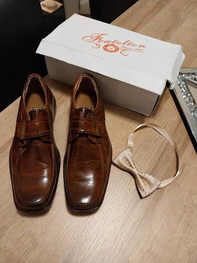 As new in box size 4 brown leather with bow tie also