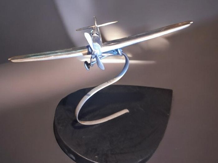1970s chrome airplane on stand