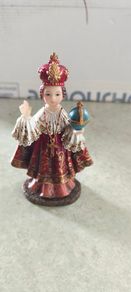 Infant of Prague devotional figurine featuring ornate red and gold robes and a matching crown.