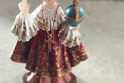 Infant of Prague devotional figurine featuring ornate red and gold robes and a matching crown.