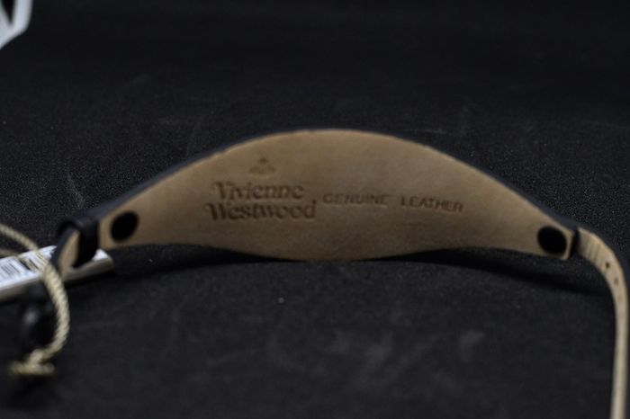 A Vivienne Westwood watch with gold face and leather strap