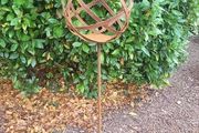 Corten steel garden sphere on a stem