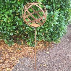 Corten steel garden sphere on a stem