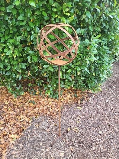 Corten steel garden sphere on a stem