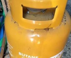 3/4 full butane gas cylinder