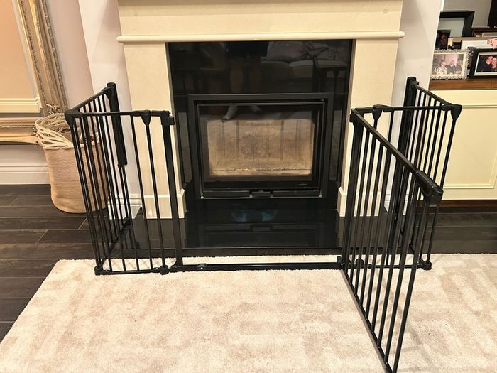 Black metal fire guard and safety gate
