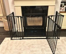 Black metal fire guard and safety gate