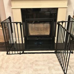 Black metal fire guard and safety gate