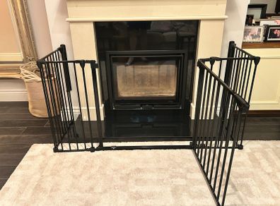 Black metal fire guard and safety gate