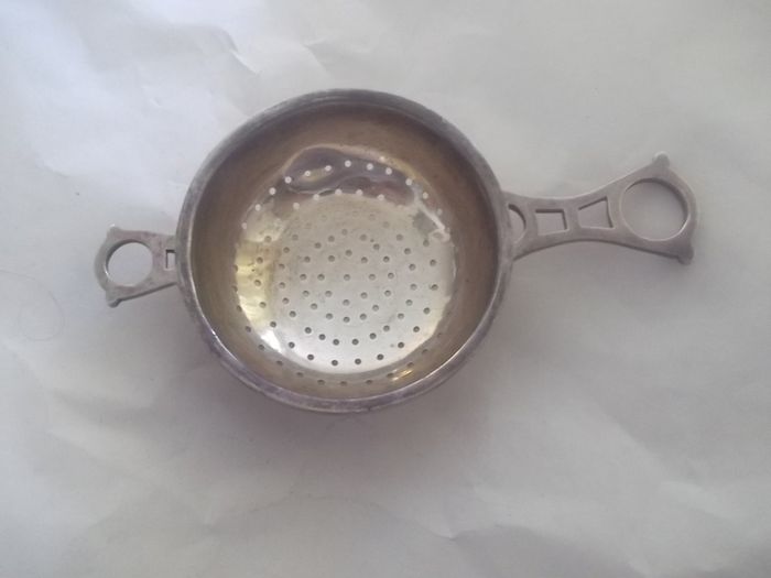 a solid  vintage silver strainer
