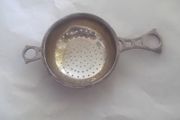 a solid  vintage silver strainer